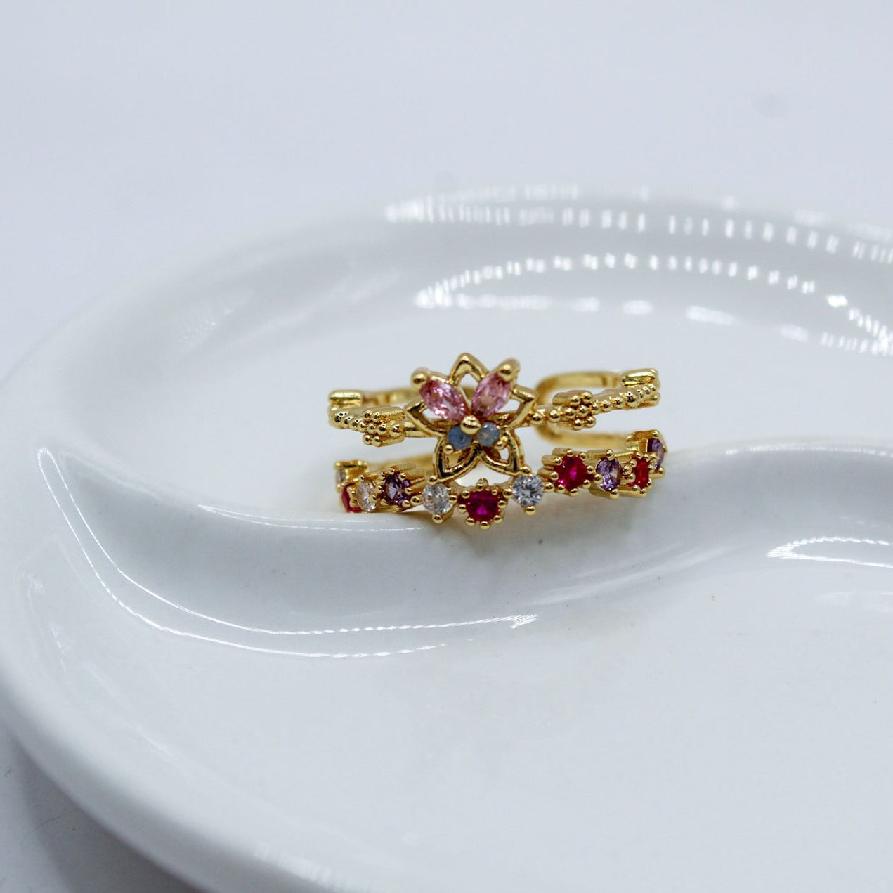 ANILLO DOS LÍNEAS ESTRELLA MARIPOSA ROSA AZUL ENMEDIO Y ZIRCONIAS ROSA BLANCAS MORADAS